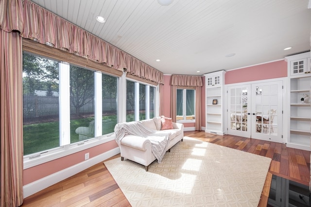 interior space with french doors, wooden ceiling, a wealth of natural light, and light wood-type flooring