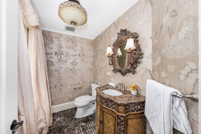 bathroom with toilet, crown molding, and vanity