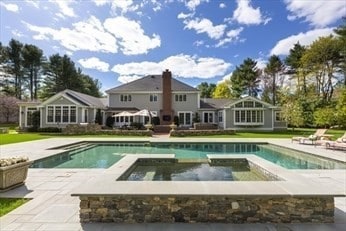 view of swimming pool with an in ground hot tub and a patio area