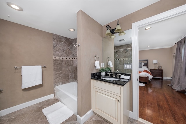 bathroom featuring vanity, hardwood / wood-style floors, shower with separate bathtub, and ornamental molding