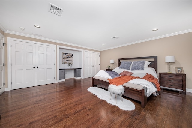 bedroom featuring built in desk, crown molding, and dark hardwood / wood-style flooring