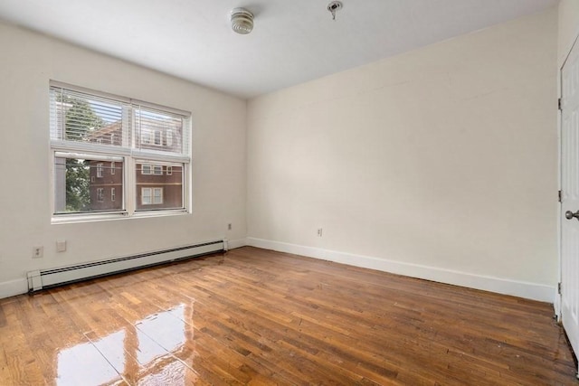 25-29 Astoria St, Boston, MA 02126 - unfurnished room featuring a baseboard radiator, baseboards, and wood-type flooring