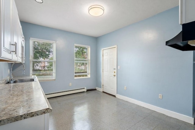 25-29 Astoria St, Boston, MA 02126 - kitchen featuring white cabinets, baseboard heating, a sink, light countertops, and baseboards