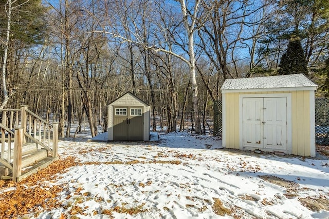 yard layered in snow with a storage unit