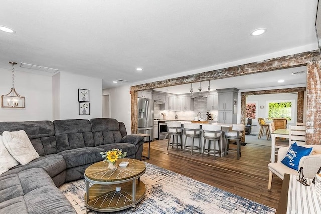 living room with dark wood finished floors and recessed lighting