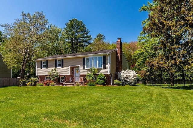 raised ranch with a chimney and brick siding