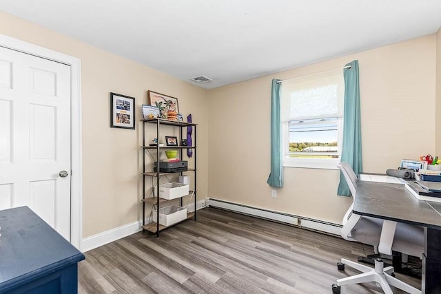 office with wood finished floors, baseboards, and a baseboard heating unit