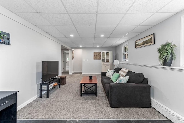 carpeted living area with a baseboard radiator, recessed lighting, baseboards, and a drop ceiling
