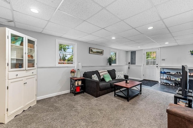 carpeted living room featuring a drop ceiling, baseboards, and recessed lighting