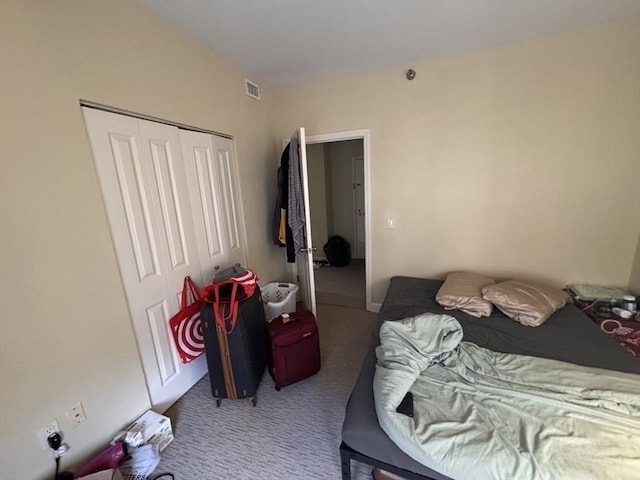 carpeted bedroom featuring a closet