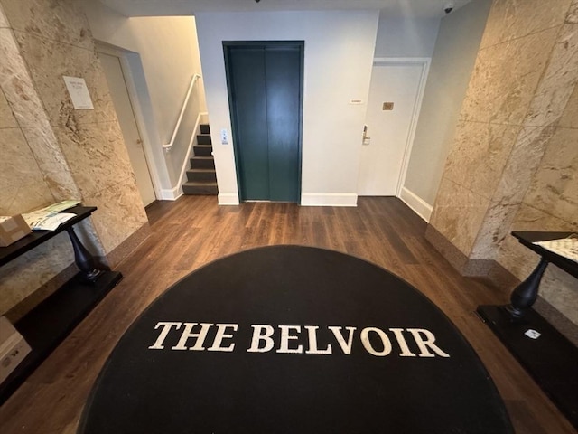 interior space featuring dark hardwood / wood-style floors and elevator