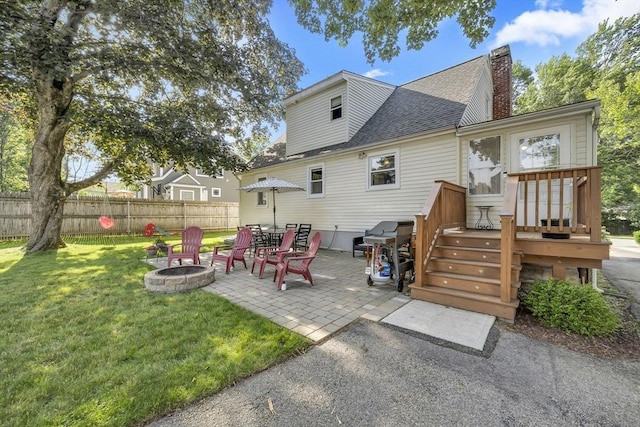 1 Walter St, Worcester, MA 01609 - rear view of house with a fire pit, roof with shingles, a deck, a patio, and a chimney
