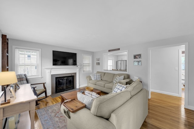 1 Walter St, Worcester, MA 01609 - living area featuring healthy amount of natural light, a fireplace with flush hearth, and light wood-style floors