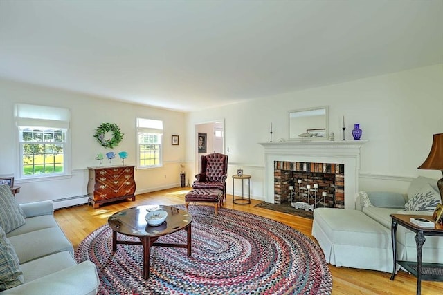 47 Fallon Dr, Westport, MA 02790 - living area featuring a brick fireplace, light wood-style floors, and a baseboard radiator