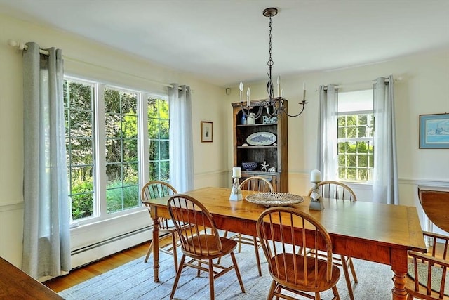 47 Fallon Dr, Westport, MA 02790 - dining area with a baseboard radiator, wood finished floors, a wainscoted wall, and a chandelier