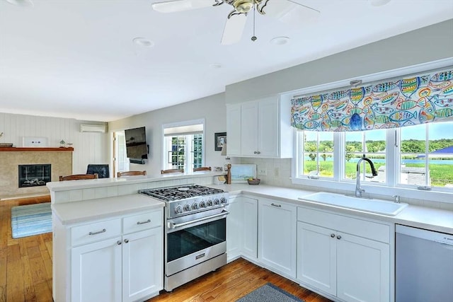 47 Fallon Dr, Westport, MA 02790 - kitchen featuring stainless steel range, dishwasher, a peninsula, open floor plan, and a wall mounted air conditioner