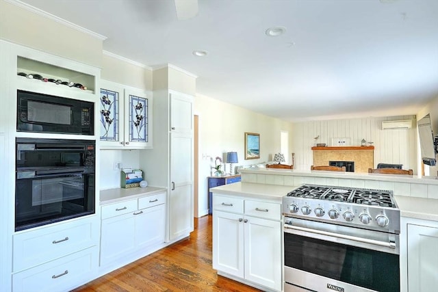 47 Fallon Dr, Westport, MA 02790 - kitchen featuring black appliances, light countertops, white cabinetry, wood finished floors, and crown molding