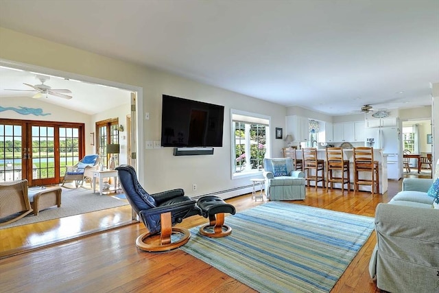 47 Fallon Dr, Westport, MA 02790 - living area featuring a ceiling fan, a baseboard radiator, light wood-type flooring, and vaulted ceiling