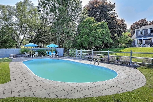 47 Fallon Dr, Westport, MA 02790 - view of swimming pool featuring a fenced backyard, a patio, outdoor dining space, and view of wooded area