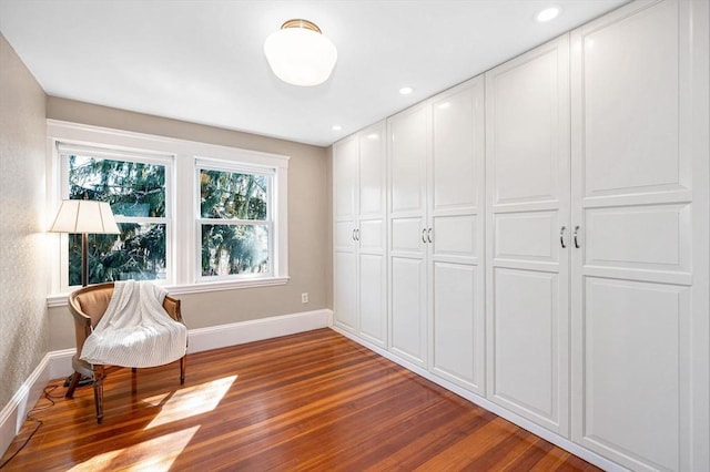 living area featuring recessed lighting, wood finished floors, and baseboards