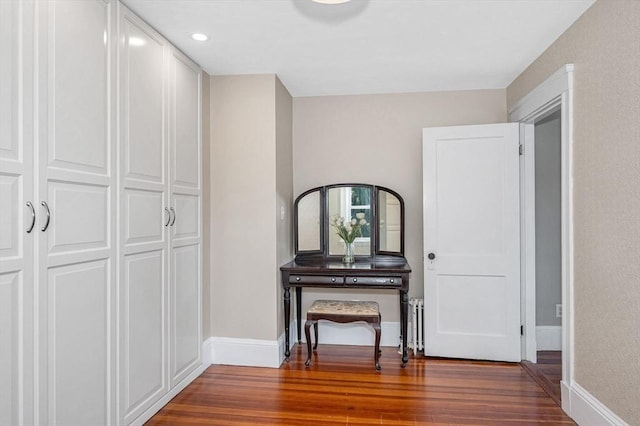 hallway featuring baseboards and wood finished floors