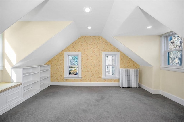 bonus room with carpet flooring, baseboards, radiator heating unit, and vaulted ceiling