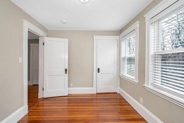 unfurnished bedroom featuring baseboards and wood finished floors