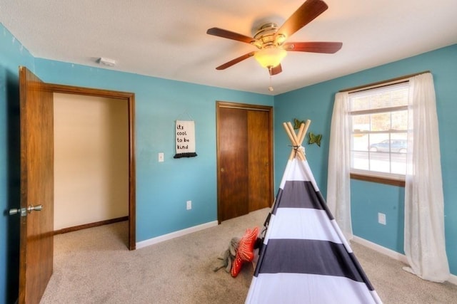 unfurnished bedroom with light carpet, ceiling fan, and a closet