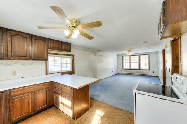 kitchen with white electric range oven, kitchen peninsula, a wall unit AC, light colored carpet, and a baseboard heating unit