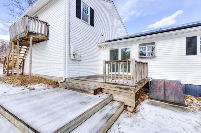 snow covered property featuring a wooden deck