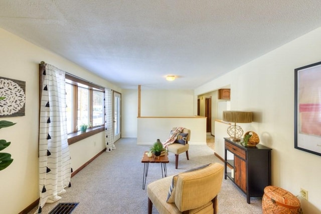 carpeted living room with a textured ceiling