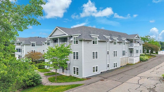 43 Kendall Ave Unit G03, Sherborn, MA 01770 - view of home's exterior featuring a balcony and roof with shingles
