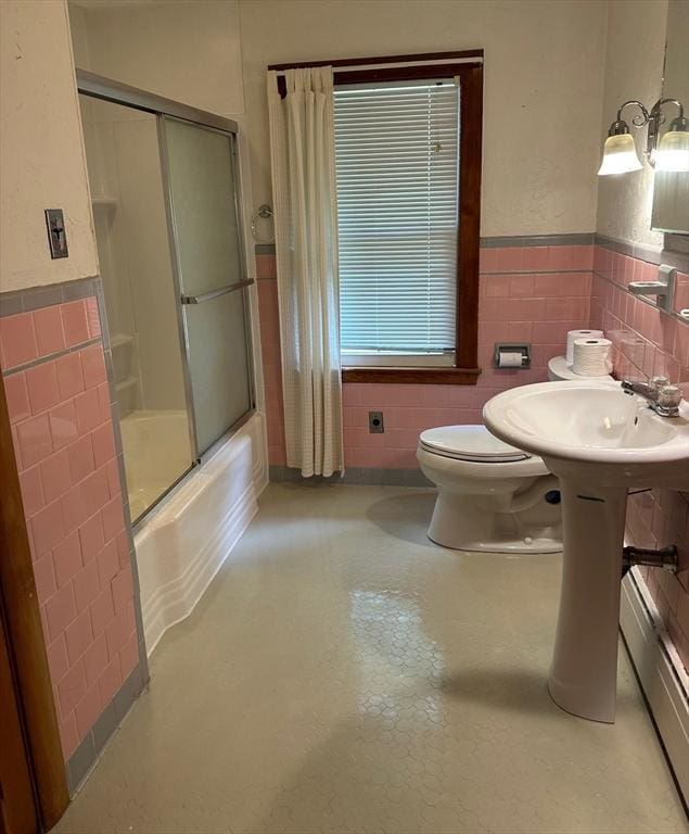 211 Stevens St, Marlborough, MA 01752 - full bath featuring tile walls, toilet, a wainscoted wall, shower / bath combination with glass door, and a baseboard radiator