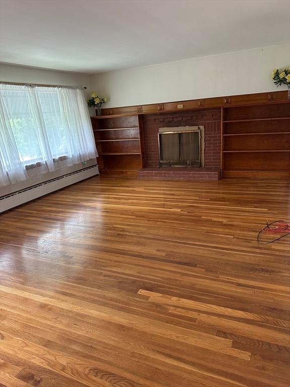 211 Stevens St, Marlborough, MA 01752 - unfurnished living room with wood finished floors, baseboard heating, and a fireplace