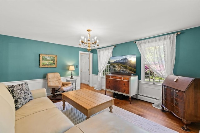 7 Stoney Hill Rd, Mattapoisett, MA 02739 - living room featuring a chandelier, wood finished floors, and wainscoting