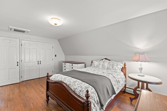 7 Stoney Hill Rd, Mattapoisett, MA 02739 - bedroom with wood finished floors, a closet, vaulted ceiling, and baseboard heating