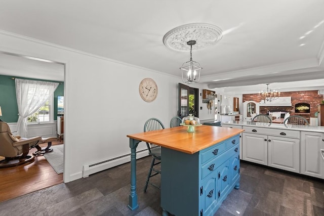 7 Stoney Hill Rd, Mattapoisett, MA 02739 - kitchen featuring a chandelier, a baseboard radiator, a breakfast bar area, blue cabinets, and white cabinetry