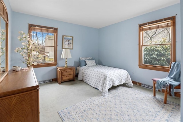 bedroom with visible vents, light colored carpet, and baseboards