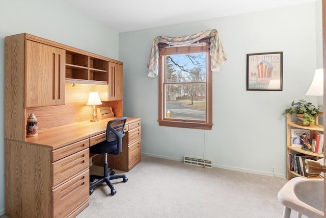 office area with visible vents, light colored carpet, and baseboards