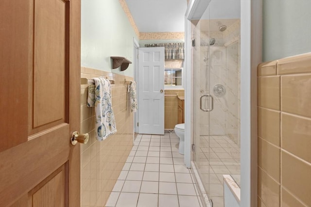 bathroom featuring tile patterned flooring, a shower stall, tile walls, and toilet