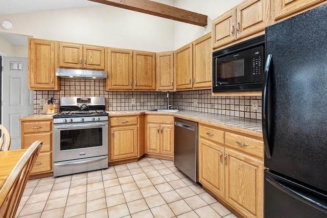 kitchen with vaulted ceiling with beams, a sink, black appliances, tile counters, and under cabinet range hood