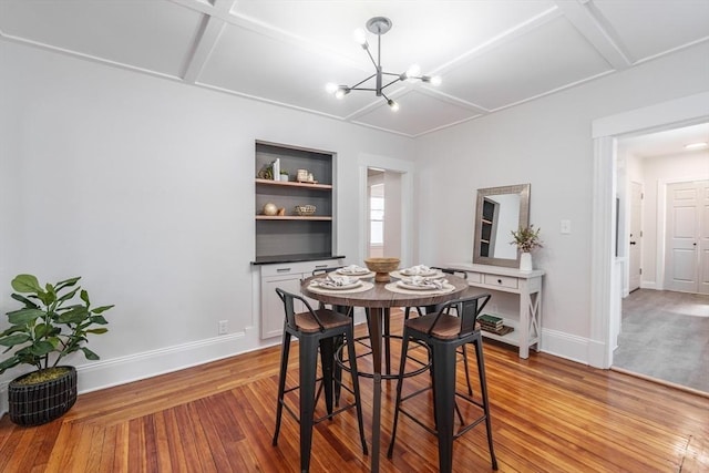 dining area featuring wood-type flooring, coffered ceiling, and an inviting chandelier