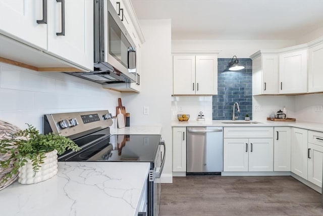 kitchen with sink, stainless steel appliances, and white cabinets