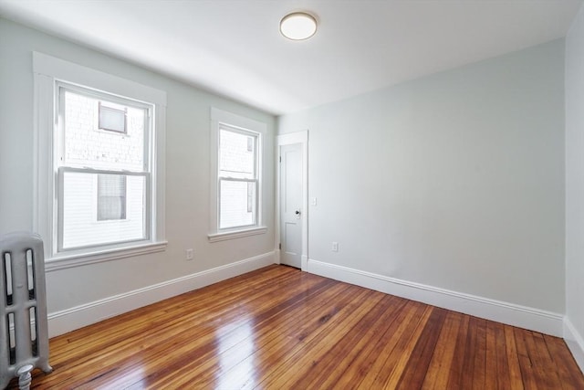 empty room with hardwood / wood-style flooring