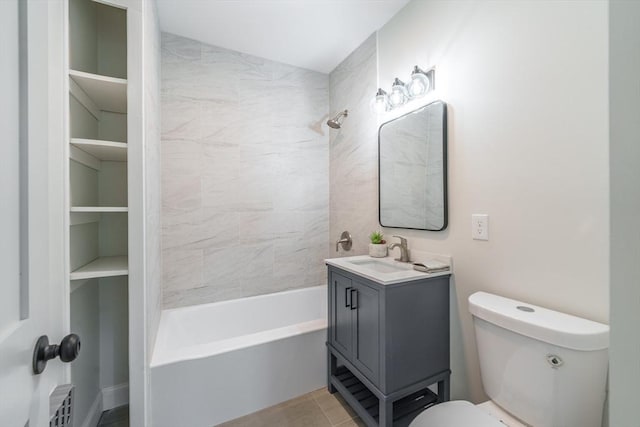 full bathroom featuring vanity, tiled shower / bath combo, and toilet