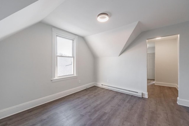 bonus room with dark wood-type flooring, a baseboard radiator, and vaulted ceiling