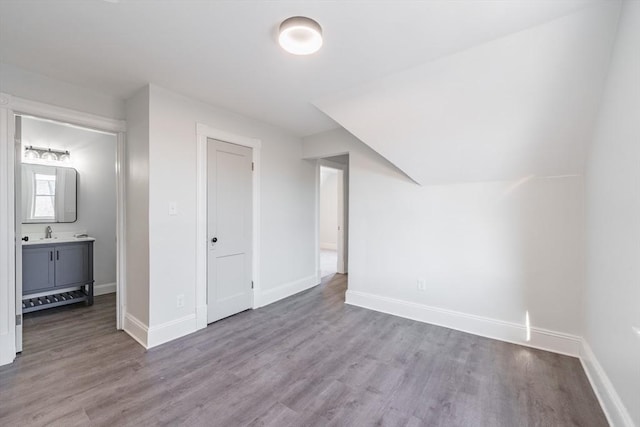 bonus room featuring sink and light hardwood / wood-style flooring