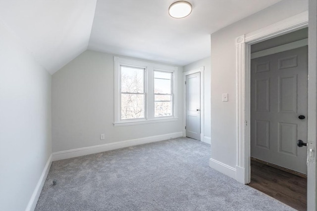 additional living space with vaulted ceiling and carpet