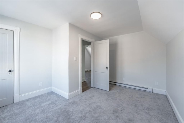 bonus room featuring baseboard heating, light colored carpet, and vaulted ceiling