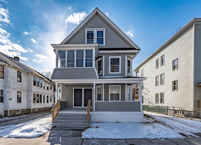 view of front of property with a porch and a sunroom